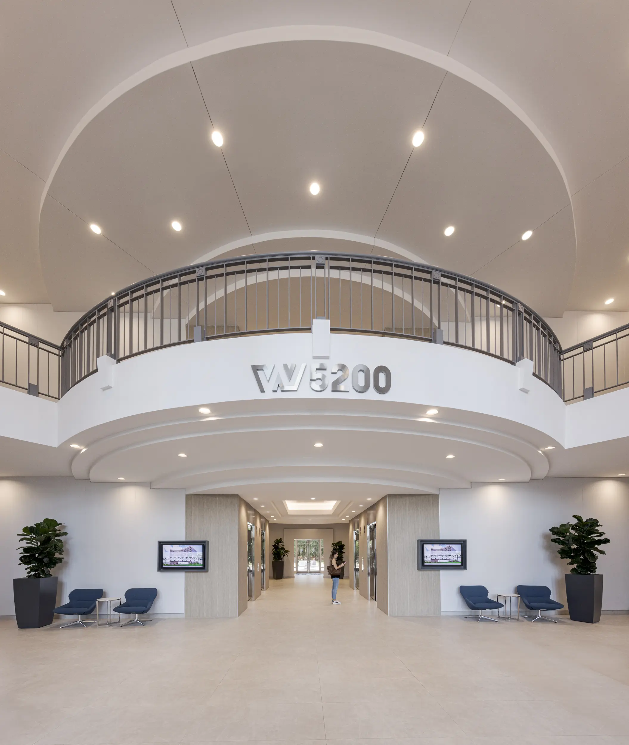 Waterford 5200 main lobby with grand curved ceiling, modern chandeliers, and a spacious open layout bathed in natural light.webp